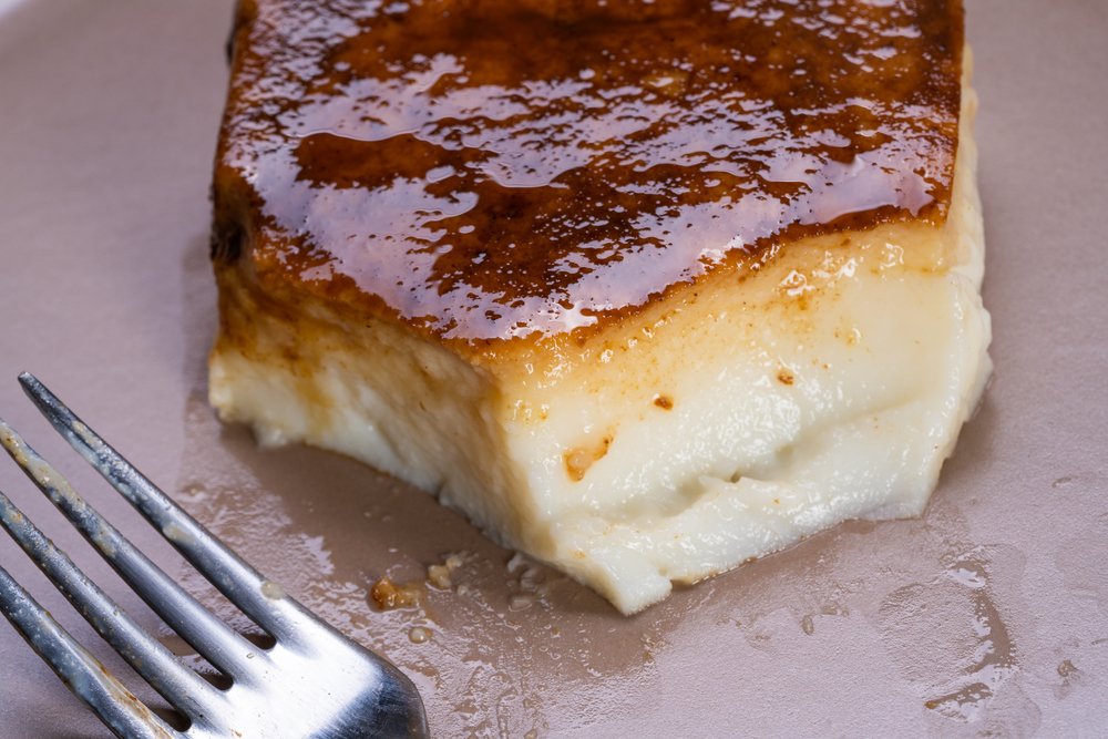 Kazandibi - a Turkish dessert on a plate with a fork, inviting you to try and know its deliciousness.