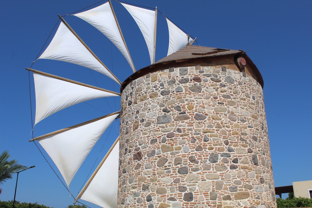 A white windmill with a sail on the Island of Kos, Greece