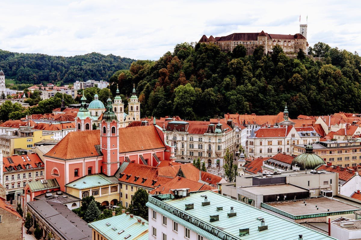 Experience the vibrant city of Ljublana with a majestic castle blending seamlessly into the backdrop, offering a breathtaking setting for your adventures.