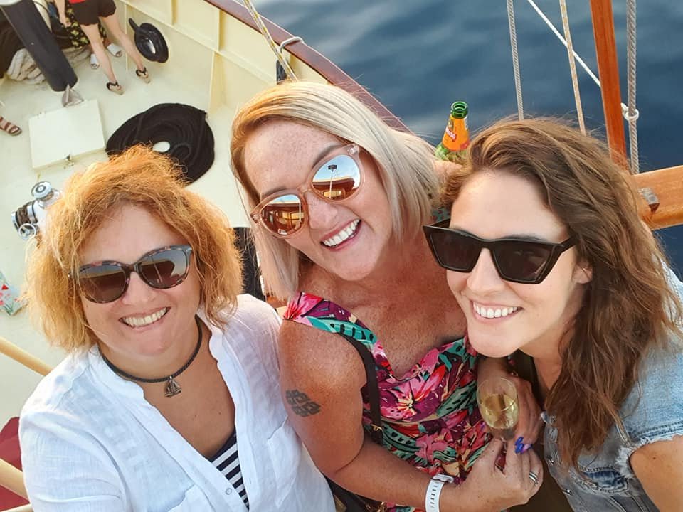 SJ, Mirela and Maria posing for a photo on a party boat in Split, Croatia.