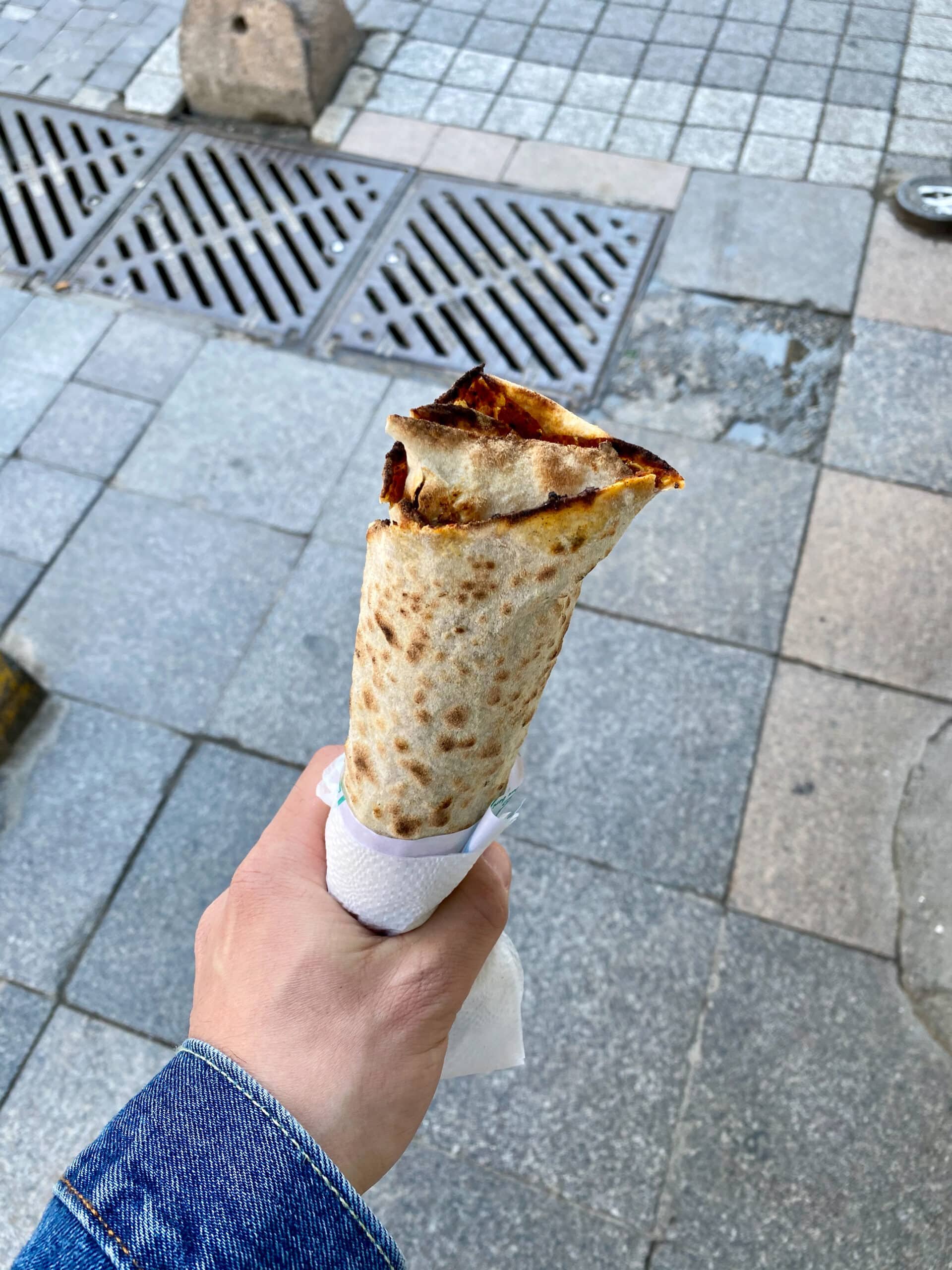 Mate enjoying istanbul street food on the sidewalk - Traditional Turkish Street Food Lahmacun 