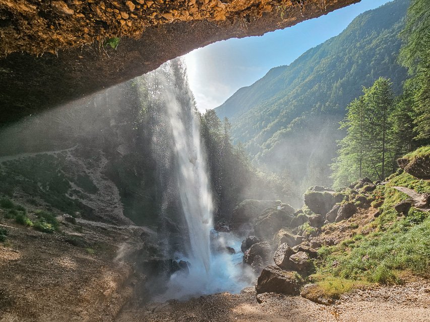 A mesmerizing cave waterfall bathed in sunlight - Slap Pericnik in Slovenia at Springtime