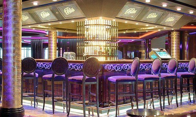 A vibrant bar on a cruise ship, illuminating the night with captivating purple lights.