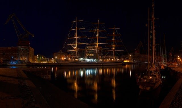 A tall ship docked in Izmir harbor at night.