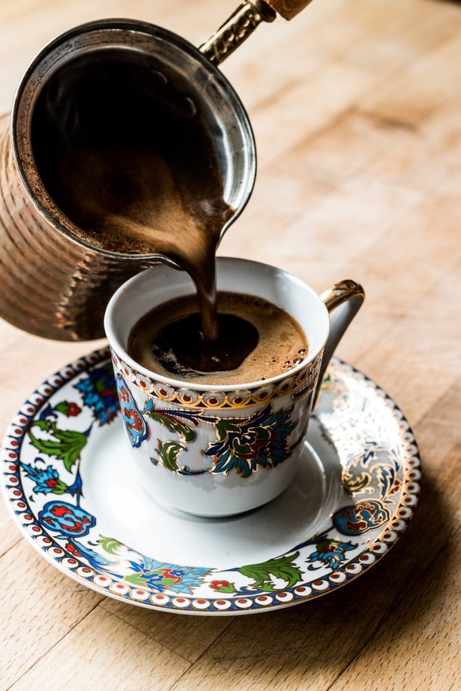 Pouring Turkish Coffee into the cup. Traditional Beverage.