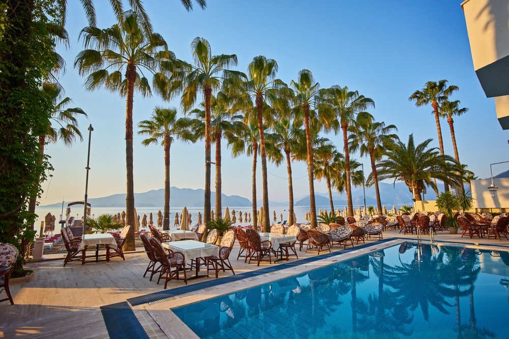 Is Marmaris worth visiting? A swimming pool with palm trees is the perfect place to relax and soak up the sun.