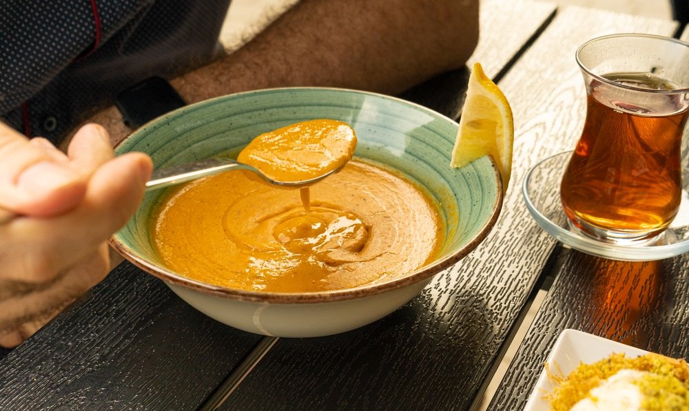 A bowl of Mercimek Yellow soup on a table in Turkey.
