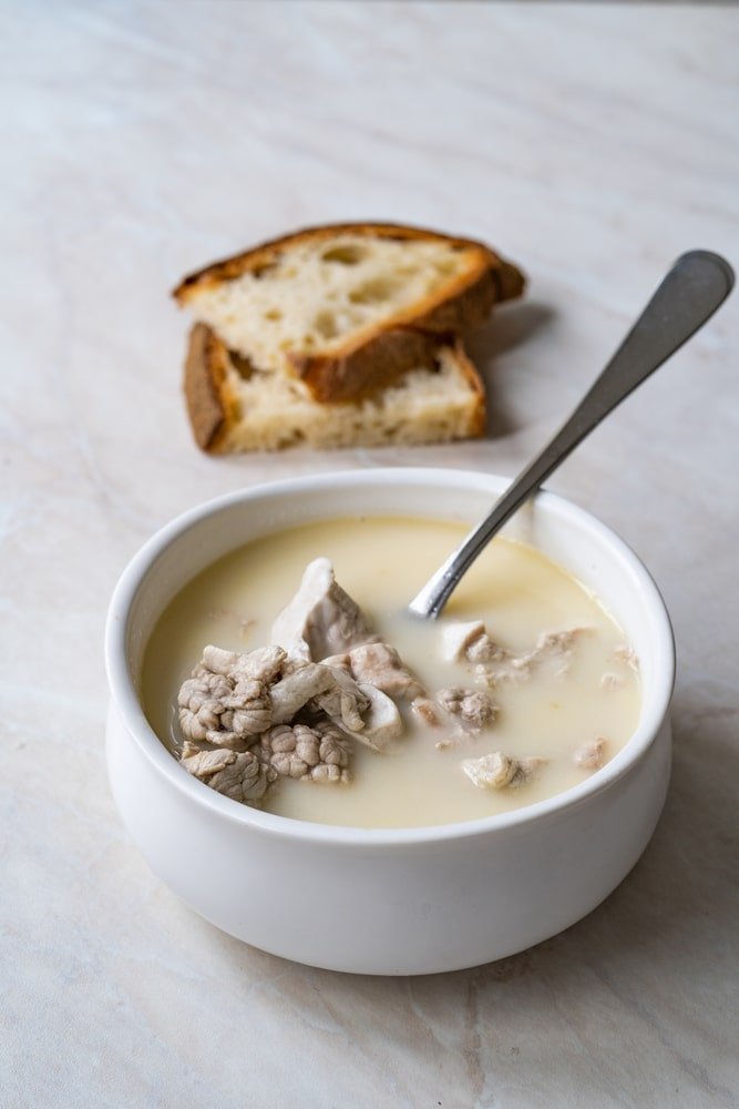 A bowl of iskembe corbasi soup with bread from Turkey.