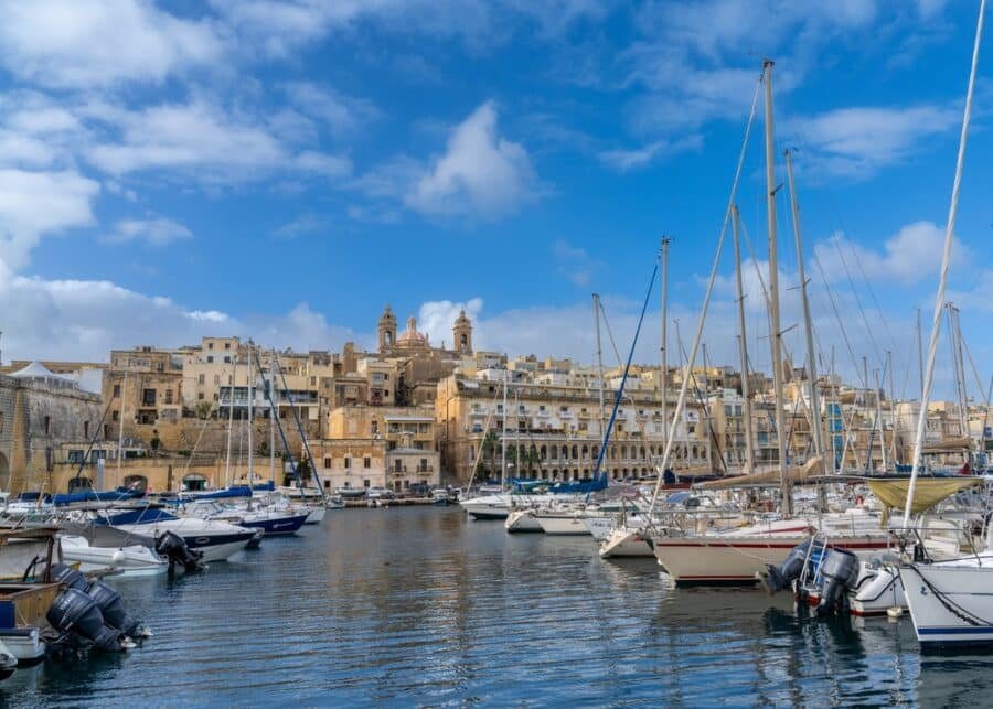 A harbor with many boats and buildings in Valletta, Malta