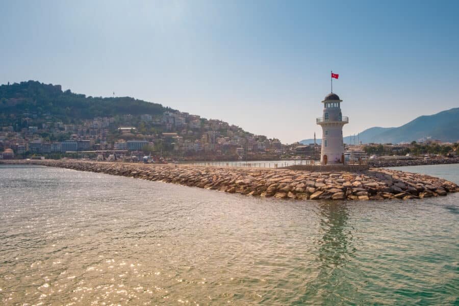 View of landscape and lighthouse of Alanya port with Turkish flag, Alanya, Turkey