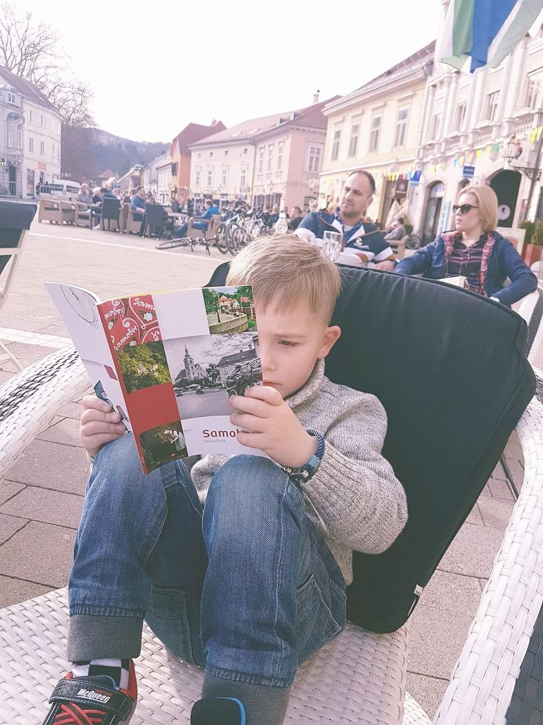 Vladimir sitting in a chair reading a book in Samobor Croatia
