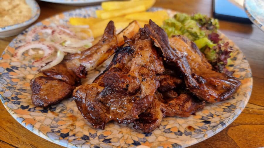 Grilled lamb chops served on a plate with french fries and a side of salad in Avanos, Cappadocia, Turkey.