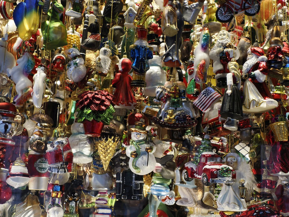 A magical Christmas display featuring an array of colorful ornaments, including Santa, snowmen, flowers, and more, hanging closely together. It's reminiscent of the festive markets in Austria—one of the top places to visit for an unforgettable holiday experience.